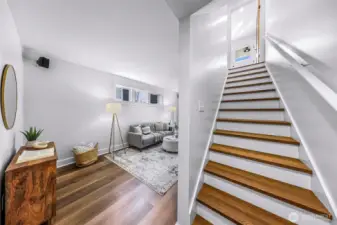 Stairs leading to the nearly 8 foot ceiling basement with new luxury vinyl plank flooring.