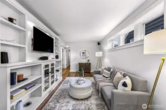 Media/family room in basement with built in, TV and speakers which stay.