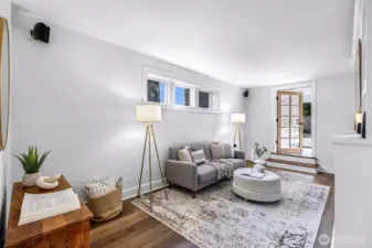 Another shot of the media room leading to the flex room with wet bar staged as an office.