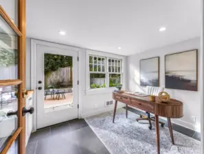 Flex room with wet bar can serve several purposes. Staged as an office and leads to back patio and backyard.