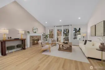 Soaring vaulted ceilings with exposed beams create a striking, elevated presence and seamless flow into the main family room