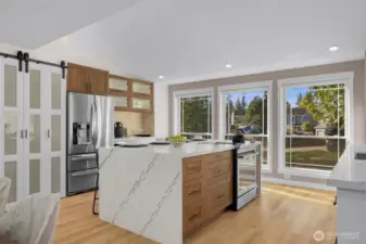 Waterfall island adds an elegant touch, complemented by timeless walnut cabinetry