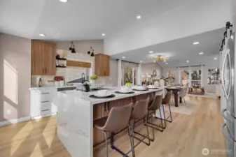 White and walnut cabinetry, quartz counters with warm veining, and black/gold hardware create a timeless, elegant look