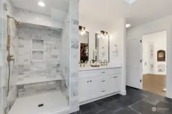 Luxurious spa-like en-suite bathroom, custom tile shower, dual sinks.