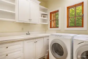 Utility room on the main level with sink and nice cabinet space