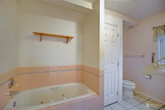 Primary bath is five piece with the shower around the corner..