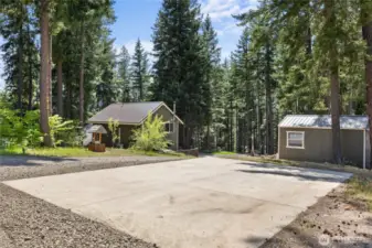 Large concrete parking pad is excellent space for trailers, RV, etc.