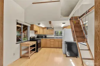 Large kitchen area has room for a corner table too! Drop down ladder here accesses the bonus room space above.