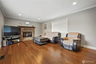 Large Living Room with fireplace and wood floors throughout.