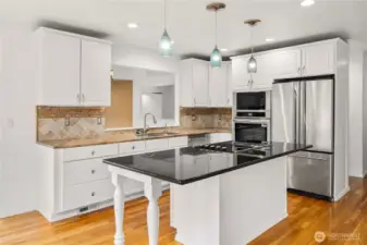 Elegant kitchen with granite counters, stainless steel appliances and comfortable Island Bar