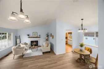 Open concept living room with dining space and vaulted ceilings.