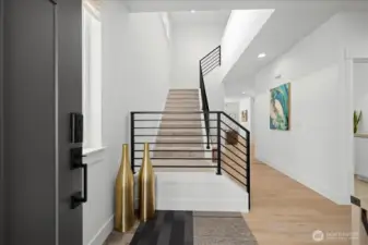 Modern Staircase with Metal Railing Adds a Contemporary Touch to the Entry