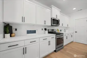 Sleek White Tile Backsplash and Shaker Cabinets for Timeless Modern Style