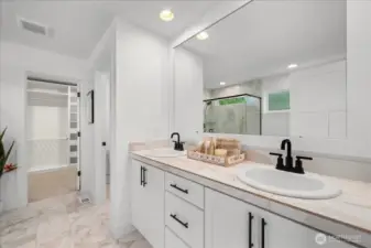 Spacious Ensuite Featuring Double Vanities and Elegant Marble Tile Flooring, Plus Floor To Ceiling Shower Surround