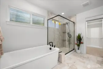 Elegant Bath Retreat Featuring a Beautiful Spacious Ensuite Featuring Double Vanities and Elegant Marble Tile Flooring, Plus Floor To Ceiling Shower Surround