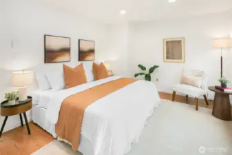 King size primary bedroom with picturesque windows and custom closet shelving.