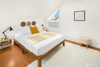 Second bedroom on upper floor features oak hardwoods with custom closet shelving as well.