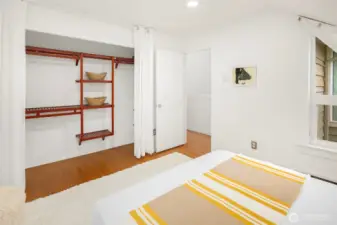 Second bedroom on upper floor features oak hardwoods with custom closet shelving as well.