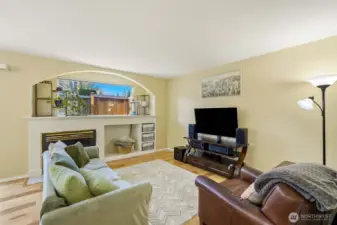 Living room with fireplace and hardwood floors.