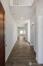 Main floor entry is open from above letting in light from clerestory window.  Colors and finishes may vary.