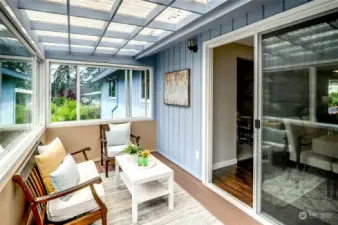 Spacious Covered Sunroom off Dining & Kitchen.  Look at all the windows--& there are more panes in the garage if you choose .