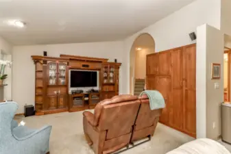 Family room, customized built in and entertainment center stays for the new homeowners