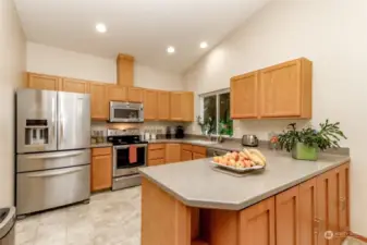 Kitchen – abundant storage, suitable for multiple chefs, breakfast bar, updated appliances, view of the North side yard