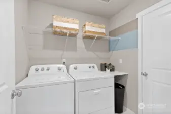 Spacious laundry room located on upper level with lots of storage. Photos are for representational purposes only. Colors and options will vary