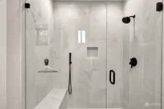 Primary bath shower with built in bench and niche.