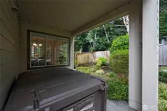 a hot tub under a covered porch