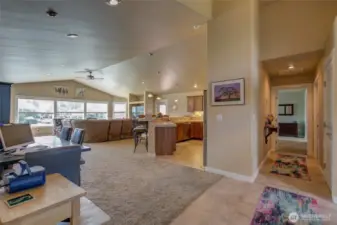 Stepping through the front door, you enter an open concept living/kitchen dining area.  Primary suite and laundry are off to the right, and the two additional bedrooms and bathroom are on the opposite side of the home, allowing for privacy.