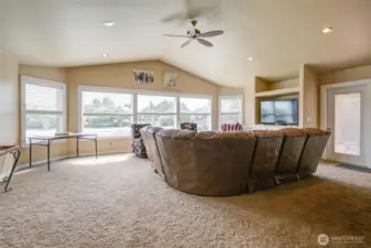 A closer look at the living room shows the vaulted ceilings and large windows.