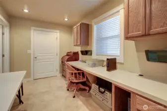 Just past the primary suite heading back to the main living space, there is an office space, which also leads to the laundry room and garage.