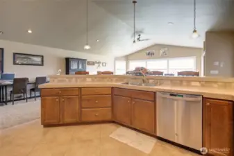 Kitchen peninsula overlooks dining and living area.