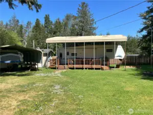 Full deck with BBQ, four handcrafted chairs and table to complete the outdoor living space all completely covered.