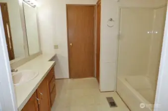 Primary bathroom with a linen closet.