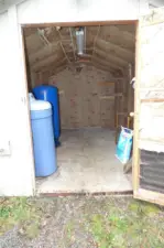 Inside shed has electricity and well components.