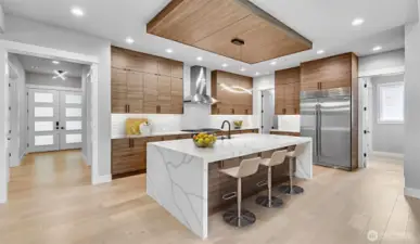 Enviable gourmet kitchen boasts 48" Subzero Refrigerator, Wolf Double-Oven, 6-Burner & Griddle Range, 48" Zephyr Pro Hood, Cove Dishwasher, Sharp Microwave Drawer, and anchored by an oversized waterfall island. Virtually staged