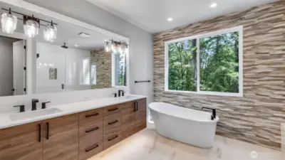 Sumptuous Primary 5-piece Bathroom featuring heated tile floor, floating double-sink vanity, soaking tub and rain shower head (not pictured).
