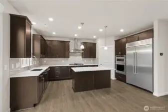 Well-appointed kitchen with gas cooktop, huge pantry adjacent to mud room just off the garage. 48" counter depth side-by-side refrigerator. Plenty of space to entertain!  Home will include white Cabinetry -