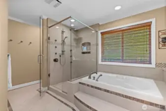 This bathroom has more! Frameless glass enclosed shower with custom tile work and niche shelf.