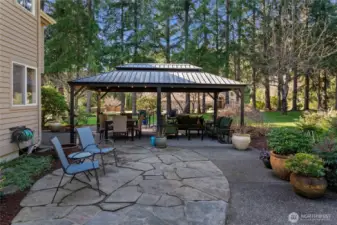 Beautifully designed with flagstone pavers, this outdoor walkway is perfect for exploring what this backyard has to offer.