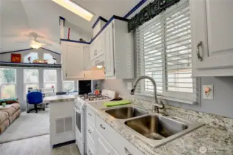 Spacious kitchen offers an abundance of cabinetry and full sized double sinks