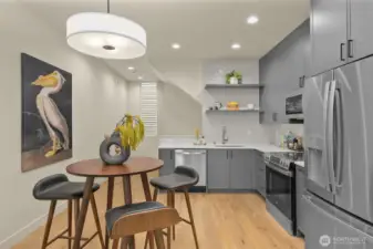 This stunning kitchen offers a large island, open shelving, and premium finishes for a polished culinary experience.