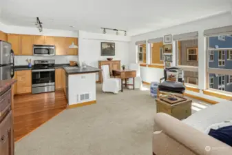 Another perspective from the spacious living room showcases the dining area and kitchen, all bathed in natural light from expansive southern windows.