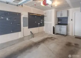 Attached Garage with Lots of Built in Shelving, Workbench, & EV Charger Ready