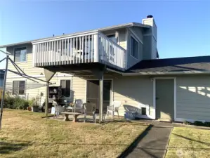 Rear of house with upper deck and patio.