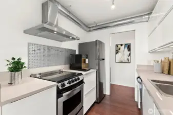 Updated kitchen with stainless steel appliances and under-cabinet lighting. Virtually staged.