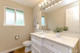Downstairs full bathroom with new vanity, sink and flooring.