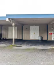 Designated carpet parking for unit #3 with storage shed for added convenience.